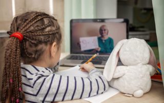 Pretty stylish schoolgirl studying math during her online lesson at home, self-isolation