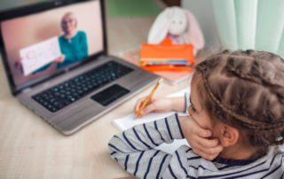 stylish schoolgirl studying math during her online lesson at home