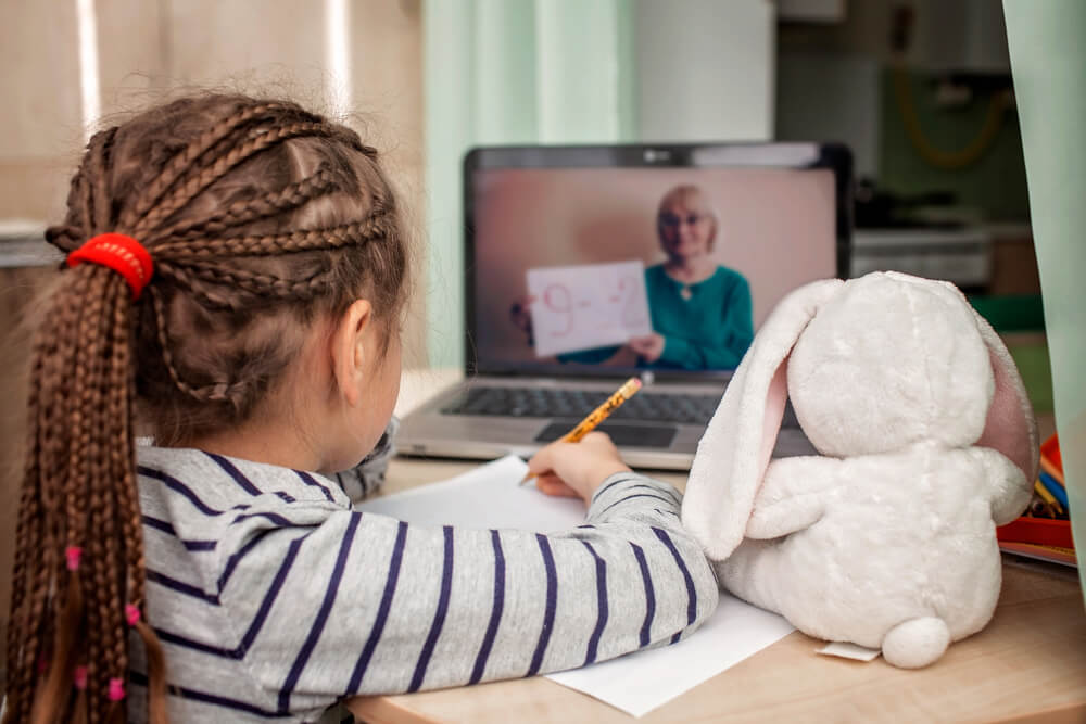 Schoolgirl Studying Math During Her Online Lesson at Home