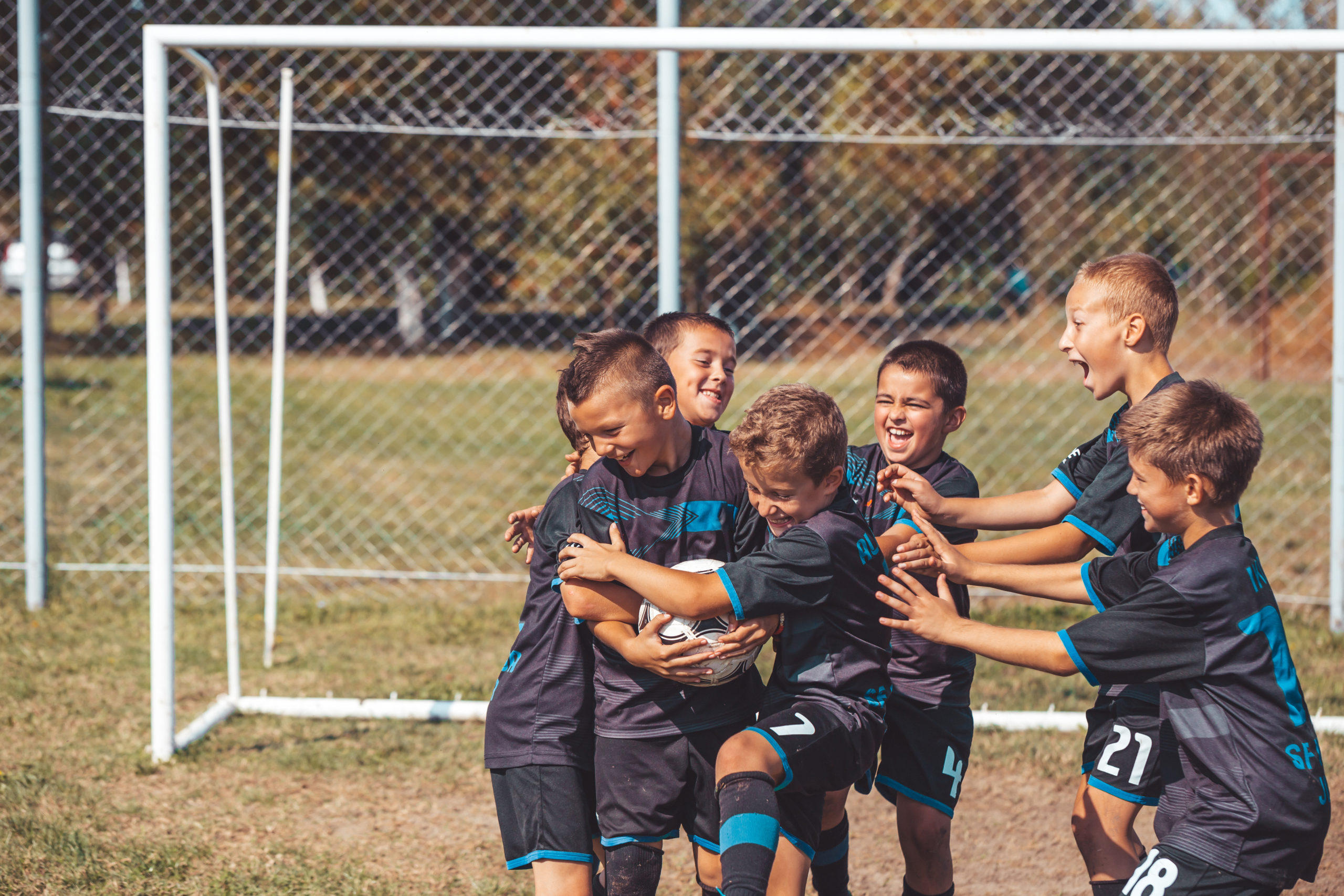 Young Football Players Celebrating New Score